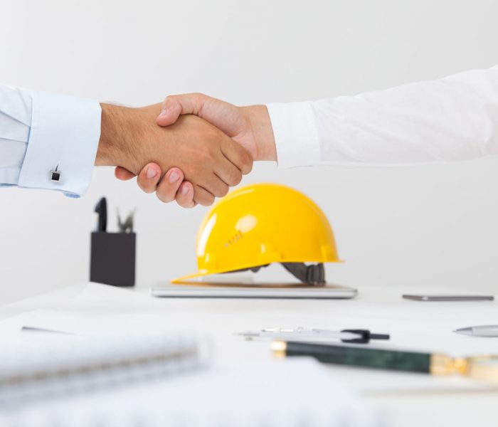 61820491 - contractor and company executive sealing a deal shaking hands. concept of new job opportunities and city development
